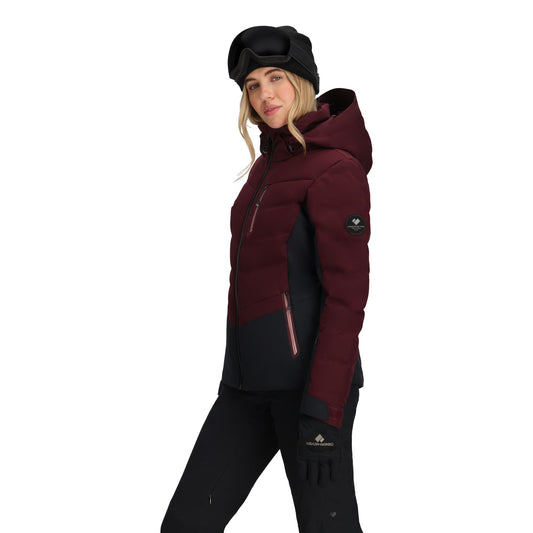 Person wearing a maroon and black winter jacket with a hood on a white background