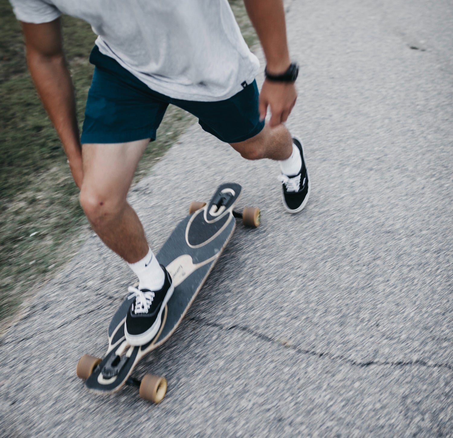 Guy longboarding on path; picture from unsplash