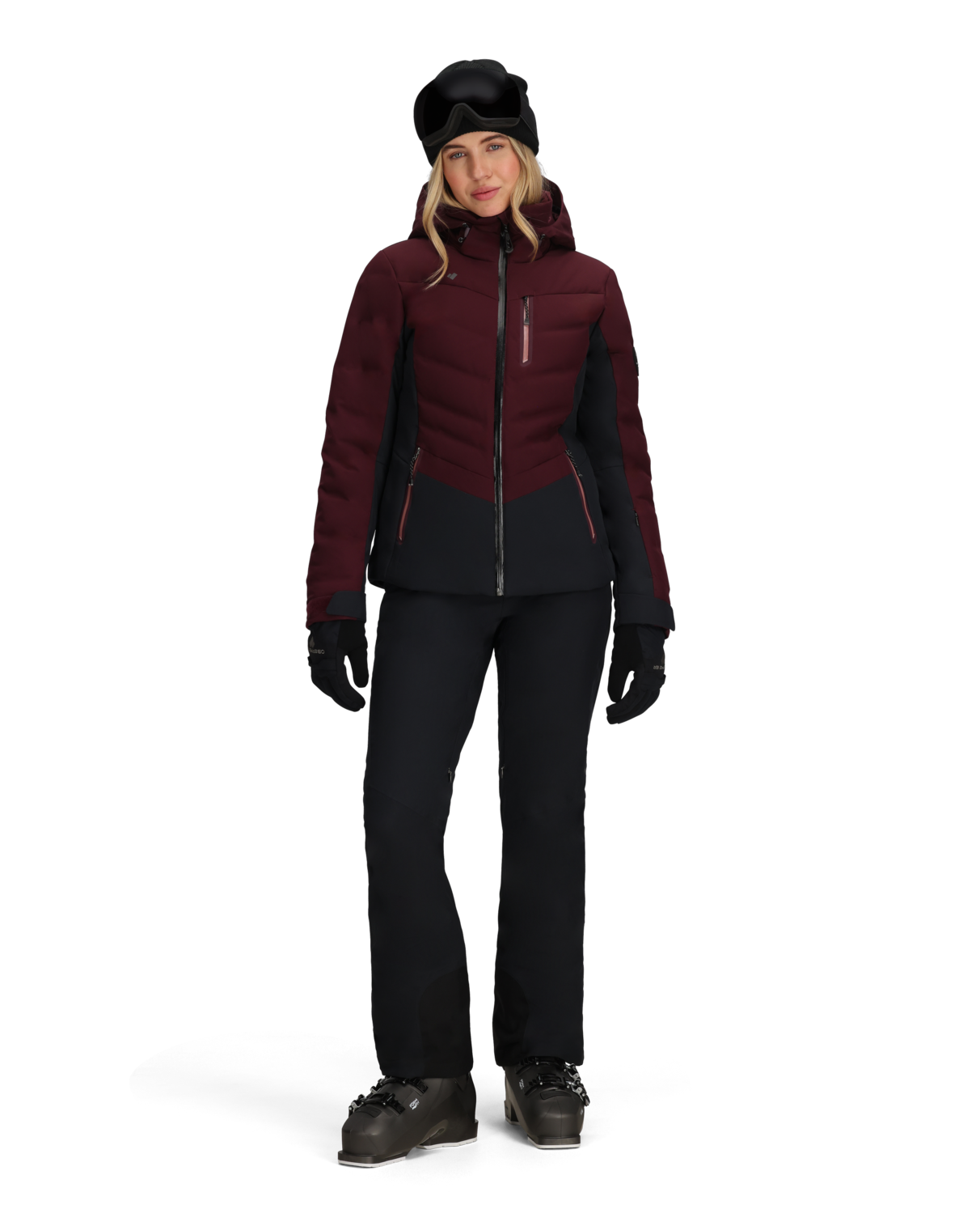 Person wearing a maroon and black winter jacket with black pants and gloves on a white background