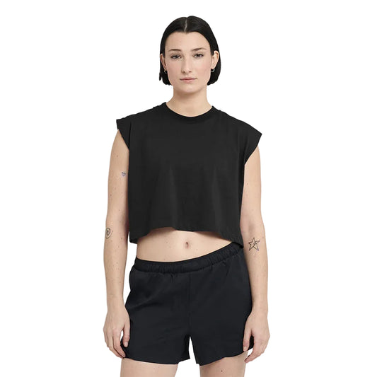 Person wearing a black sleeveless top and shorts on a white background