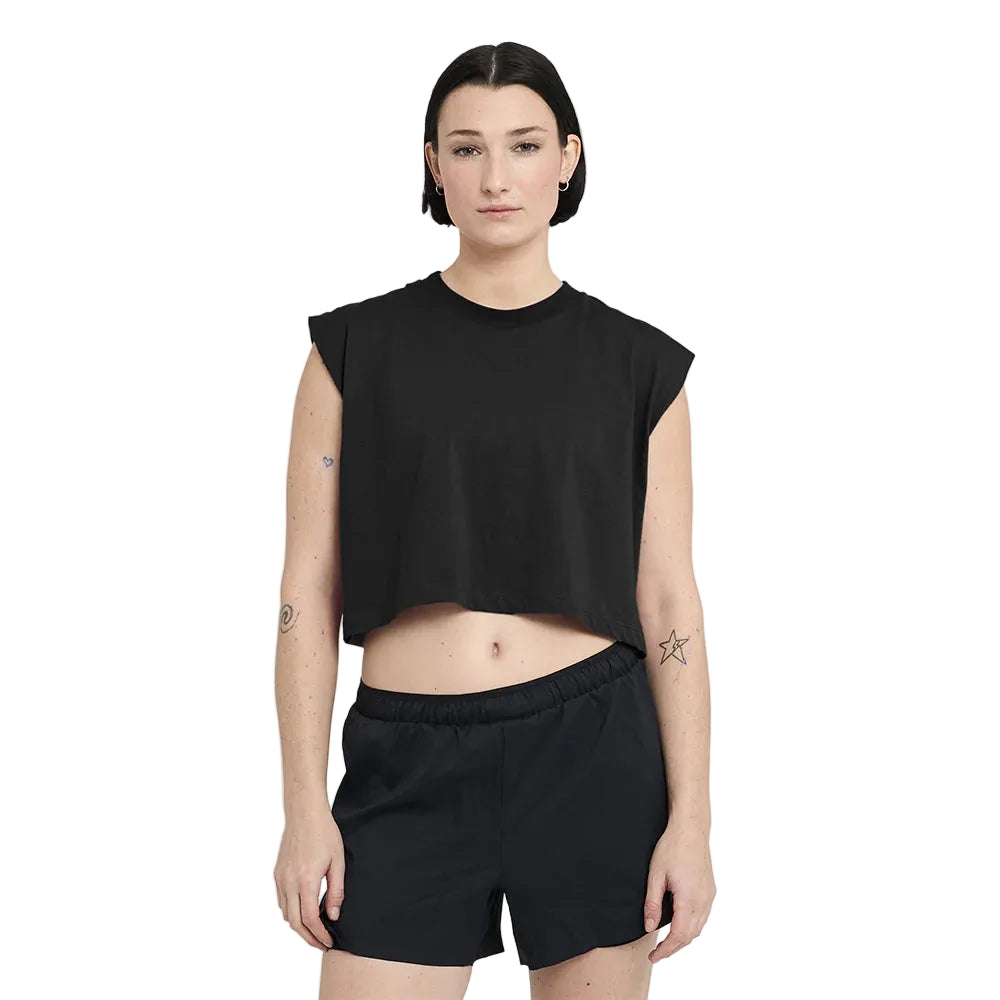 Person wearing a black sleeveless top and shorts on a white background